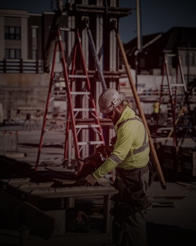 Tradesperson cutting material with a circular saw at a jobsite table